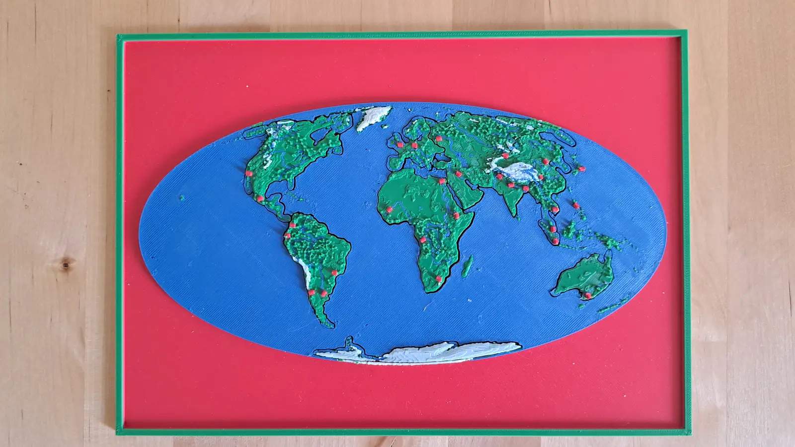 The World relief puzzle map in its red frame